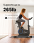 A person is riding a Renpho UK AI Smart Bike S in a bright room with two windows and blinds. Text on the image states "Supports up to 265lb" and highlights features like "Sturdy Carbon Steel Frame" and "265lb Weight Capacity." The person is wearing workout clothes, using an AI Gym App, and the bike is on a black mat.