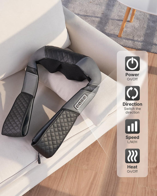 A black Renpho U-Neck 2 Neck & Shoulders Massager with control buttons rests on a white sofa, emphasizing its ergonomic design and comfort. Icons indicate its features: power on/off, direction switch, and variable speed settings.